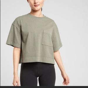 black Athleta crop tee with front pocket